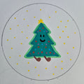 Hand-drawn green tree with a happy face on a white background with yellow dots.